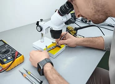Laptop and tablet parts on a repair bench